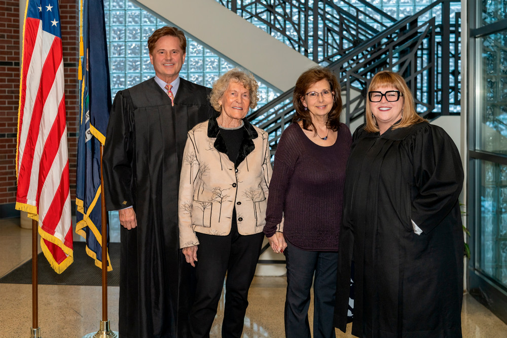 (From left) Judge Steven Bieda swore in reelected Macomb Community College trustee Joan Flynn. Reelected trustee Roseanne DiMaria was sworn in by Judge Kathleen Galen.